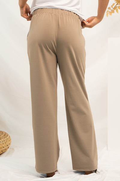 Back view of women's khaki dress pants showing elastic waistband and wide legs.
