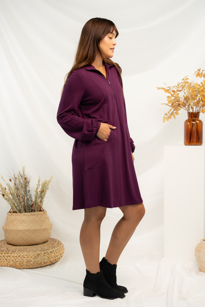 Side view of a purple bamboo knee length dress with balloon sleeves and zip collar.