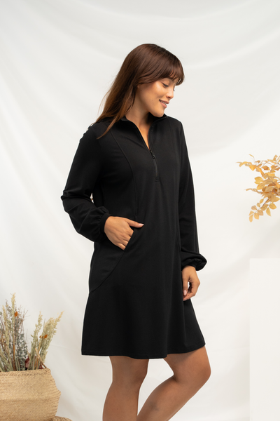 A side view of a black a-line balloon sleeve dress.