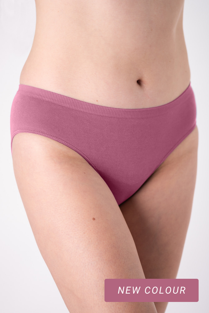 Person wearing a pair of pink underwear on a white background