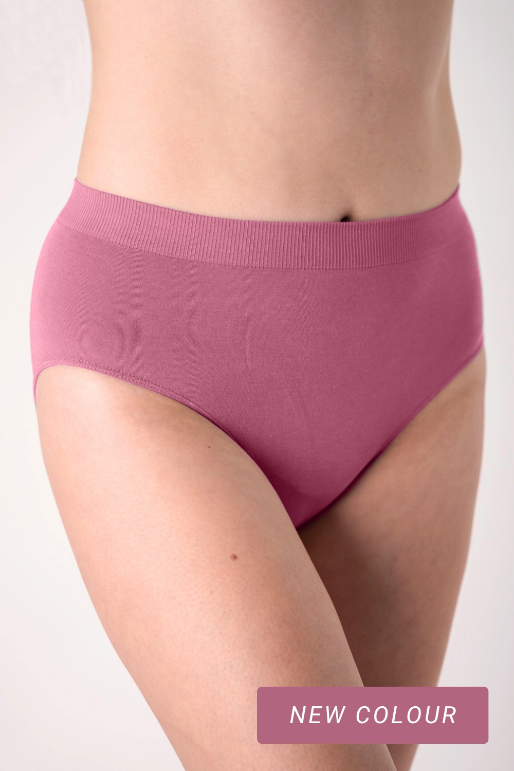 Person wearing berry pink high waisted underwear made from sustainable bamboo fabric. 