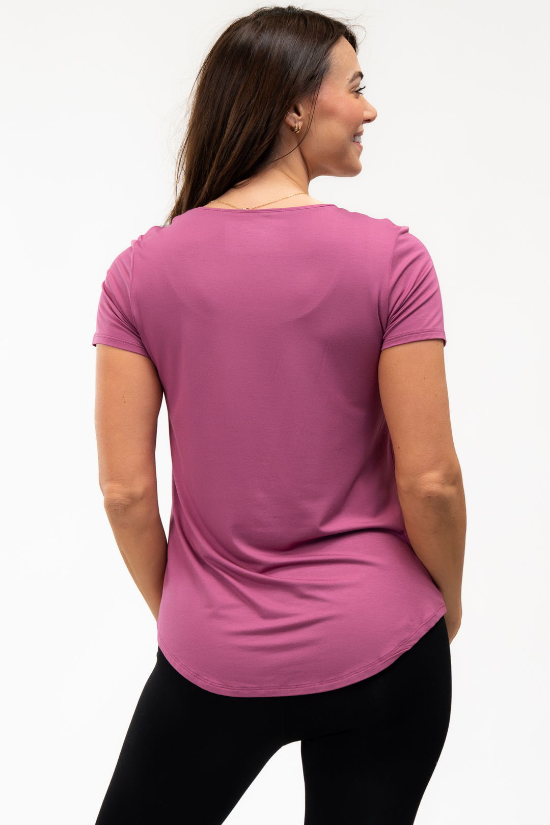 Woman wearing a pink bamboo t-shirt on a white background showing the back view