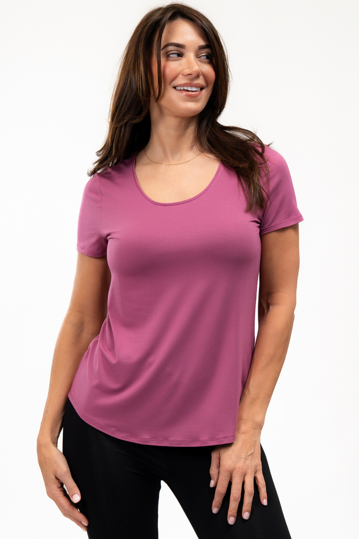 Woman wearing a pink bamboo t-shirt on a white background