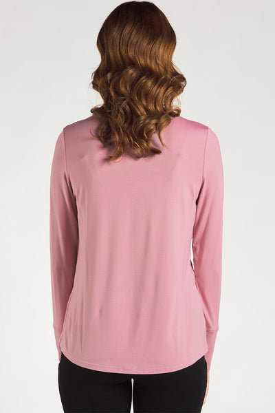 Back view of a woman styling a Pink long sleeve funnel-neck top from Terrera.