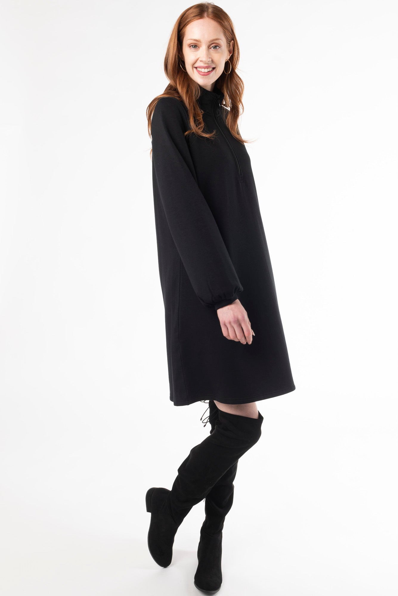 Side view of a woman wearing a Black puff sleeve dress made of bamboo fleece by Terrera, a Canadian sustainable bamboo clothing brand.