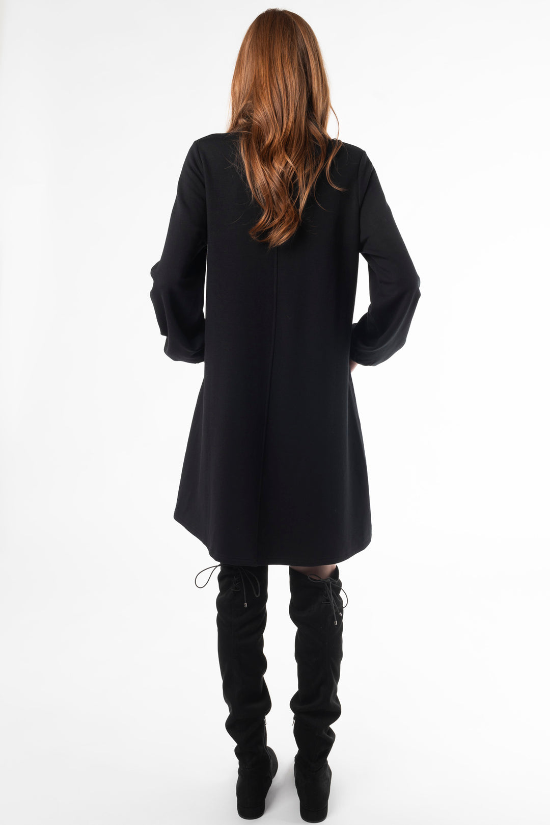 Back view of a woman modeling a puff sleeve dress in Black by Terrera.