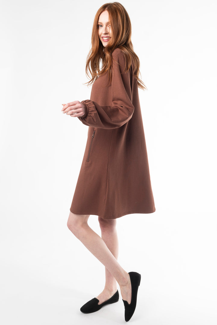 Side view of a woman wearing a Black puff sleeve dress made of bamboo fleece by Terrera, a Canadian sustainable bamboo clothing brand.