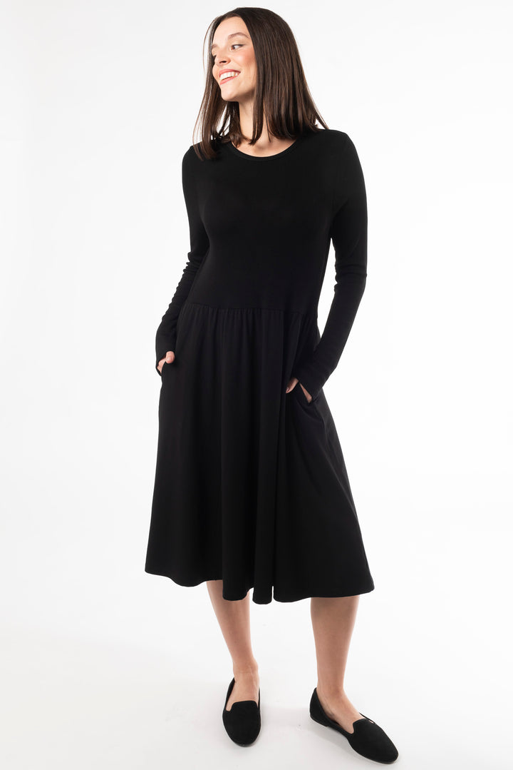 A woman modeling a long sleeve dress for fall. Made with bamboo fabric, a sustainable dress for women dress for women.