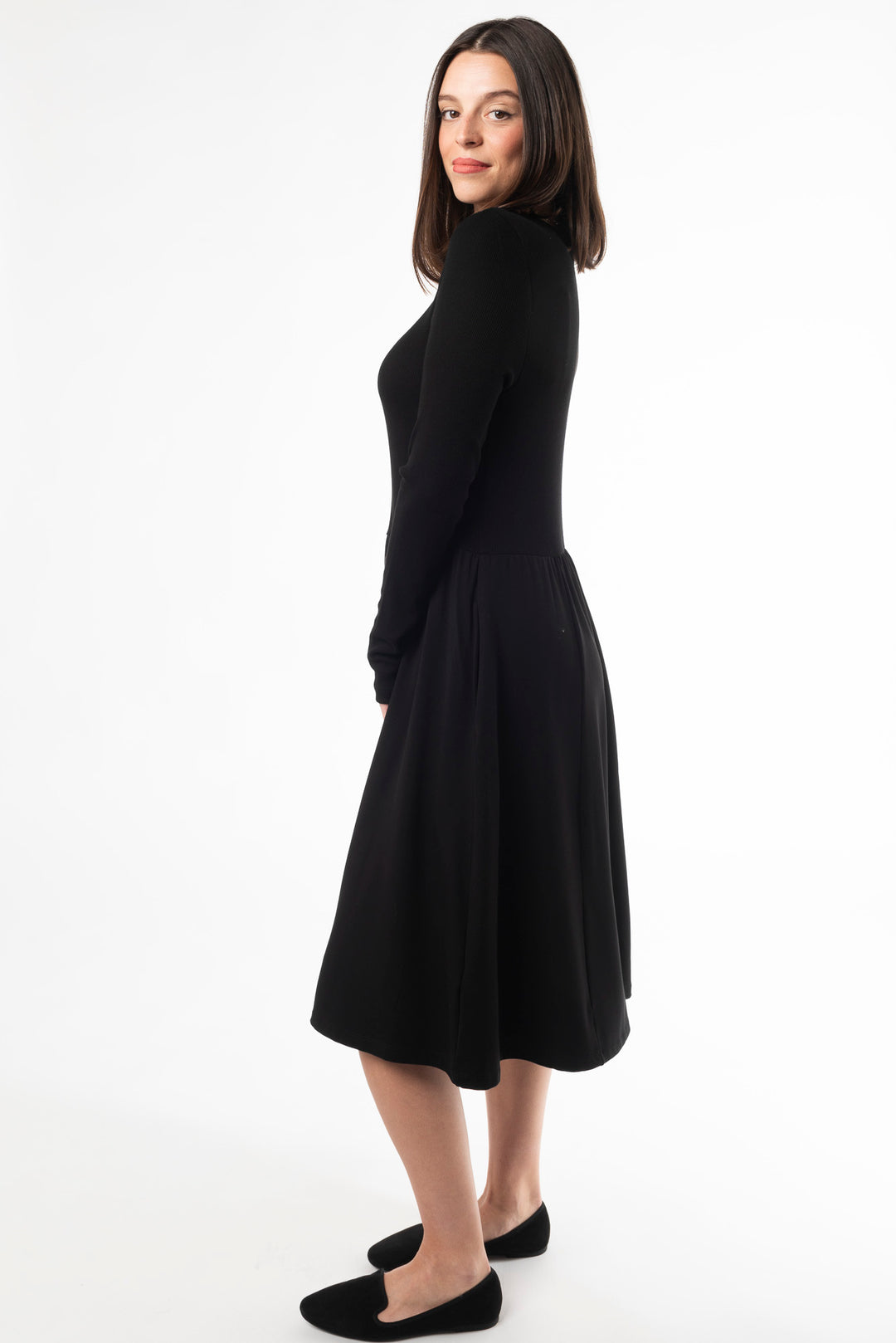 Side view of a woman wearing a Black long sleeve dress made of bamboo by Terrera, a Canadian sustainable bamboo clothing brand.