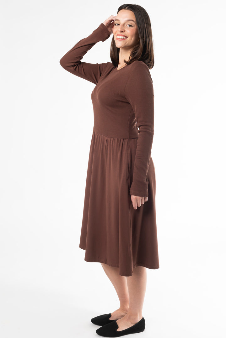 Side view of a woman wearing a Black long sleeve dress made of bamboo by Terrera, a Canadian sustainable bamboo clothing brand.
