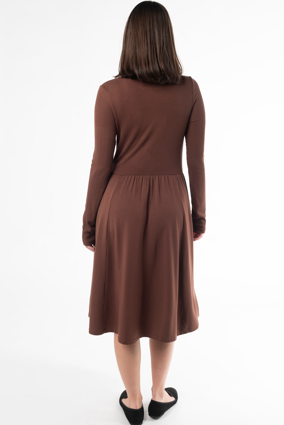 Back view of a woman modeling a brown midi dress in the colour Cocoa by Terrera.