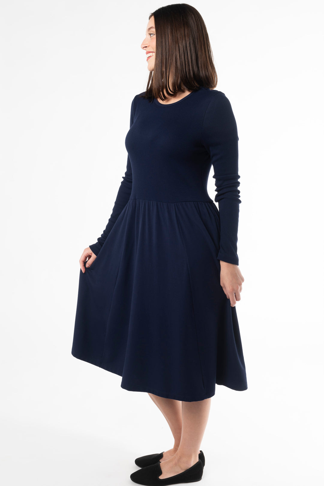 Side view of a woman wearing a navy long sleeve dress made of bamboo by Terrera, a Canadian sustainable bamboo clothing brand.