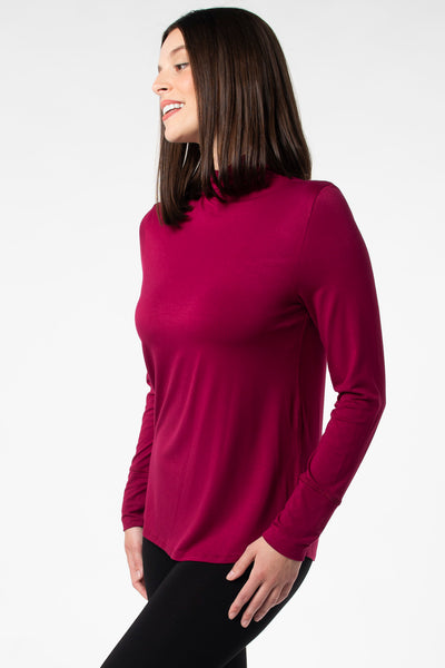 Side view of a woman wearing a bamboo long sleeve top made of sustainable bamboo fabric. 