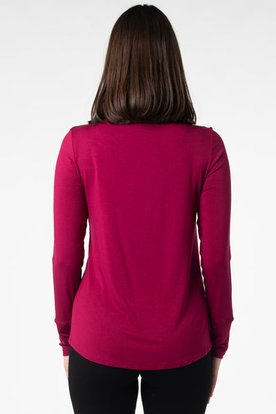 Back view of a woman modeling a funnel-neck long sleeve in the colour Beet Red.