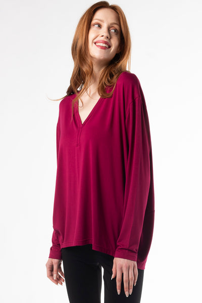 Chic bamboo long sleeve cocoon top, perfect for a comfortable and eco-conscious wardrobe. Shown in the colour ‘Beet Red’ which is a vibrant red/pink colour. 