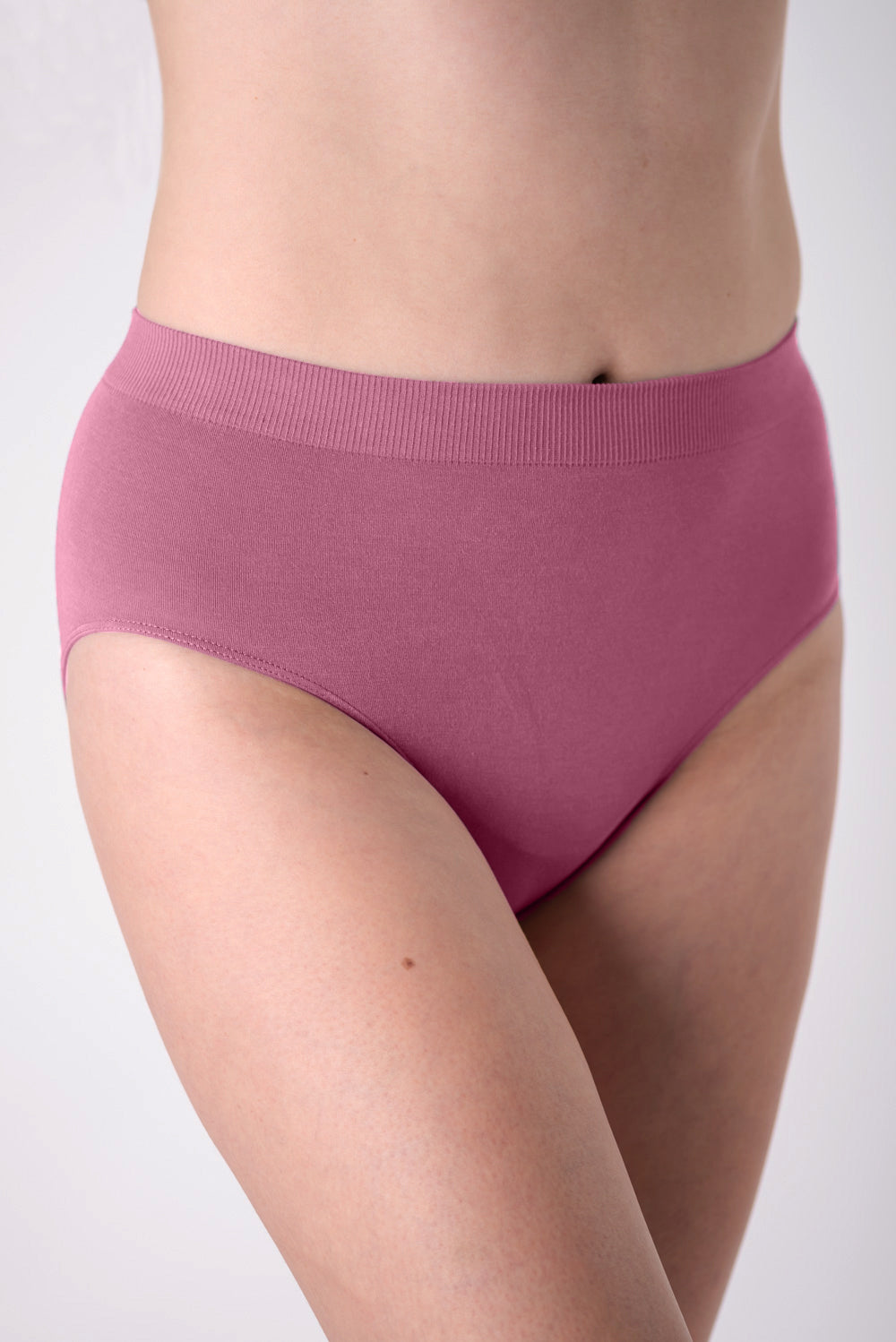 Pink high-waisted underwear on a plain background