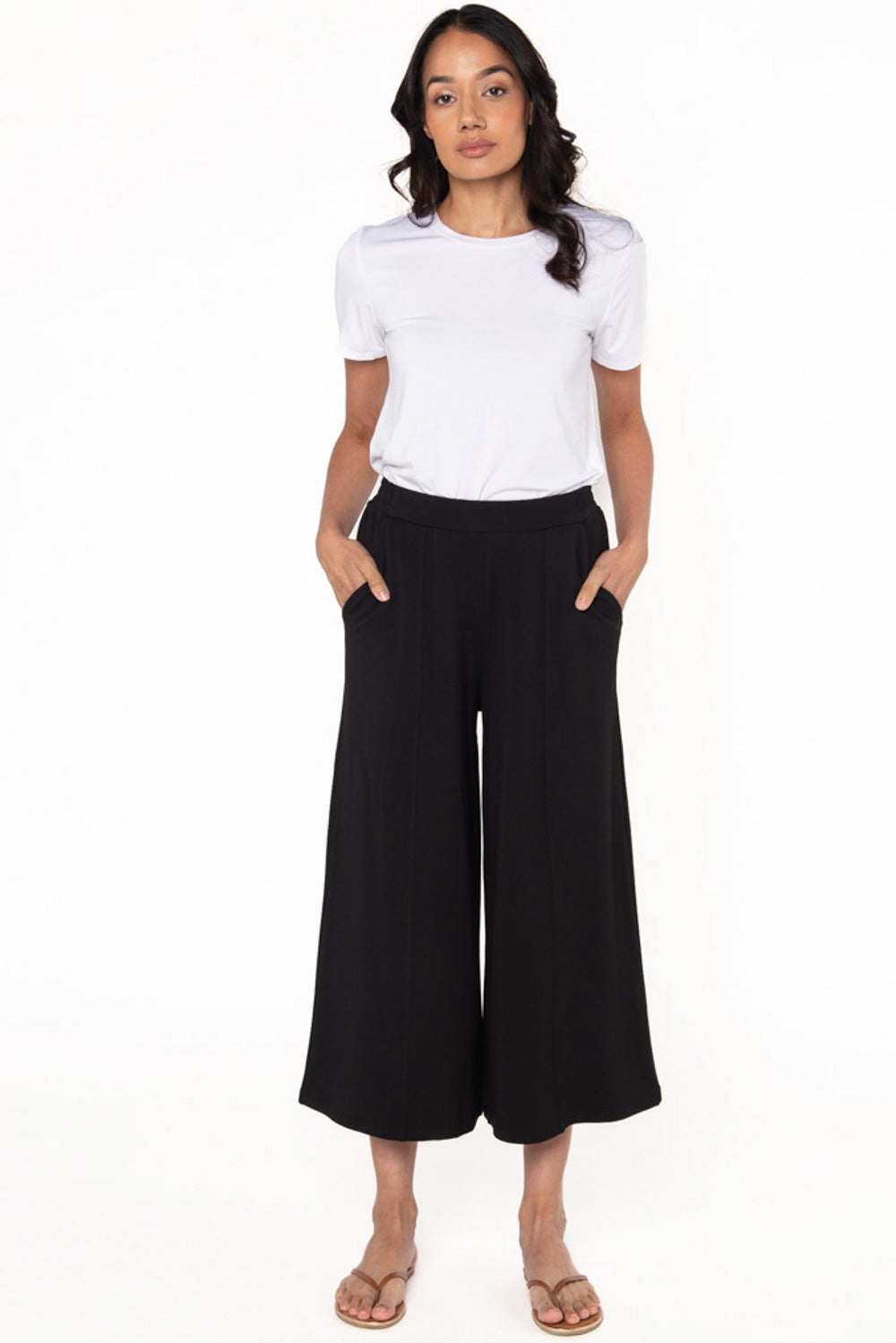 A white bamboo t-shirt with a crew neckline by Terrera paired with black culotte pants. 