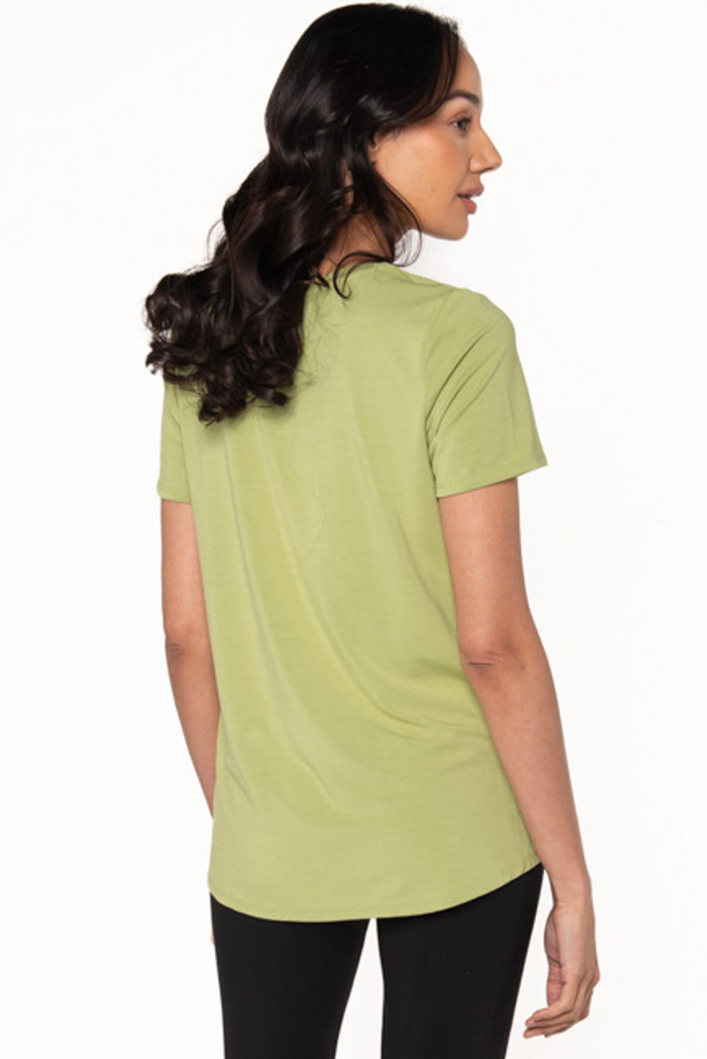 A model showing the back of a bamboo short sleeve t-shirt in a light green colour called Citron made by Terrera.