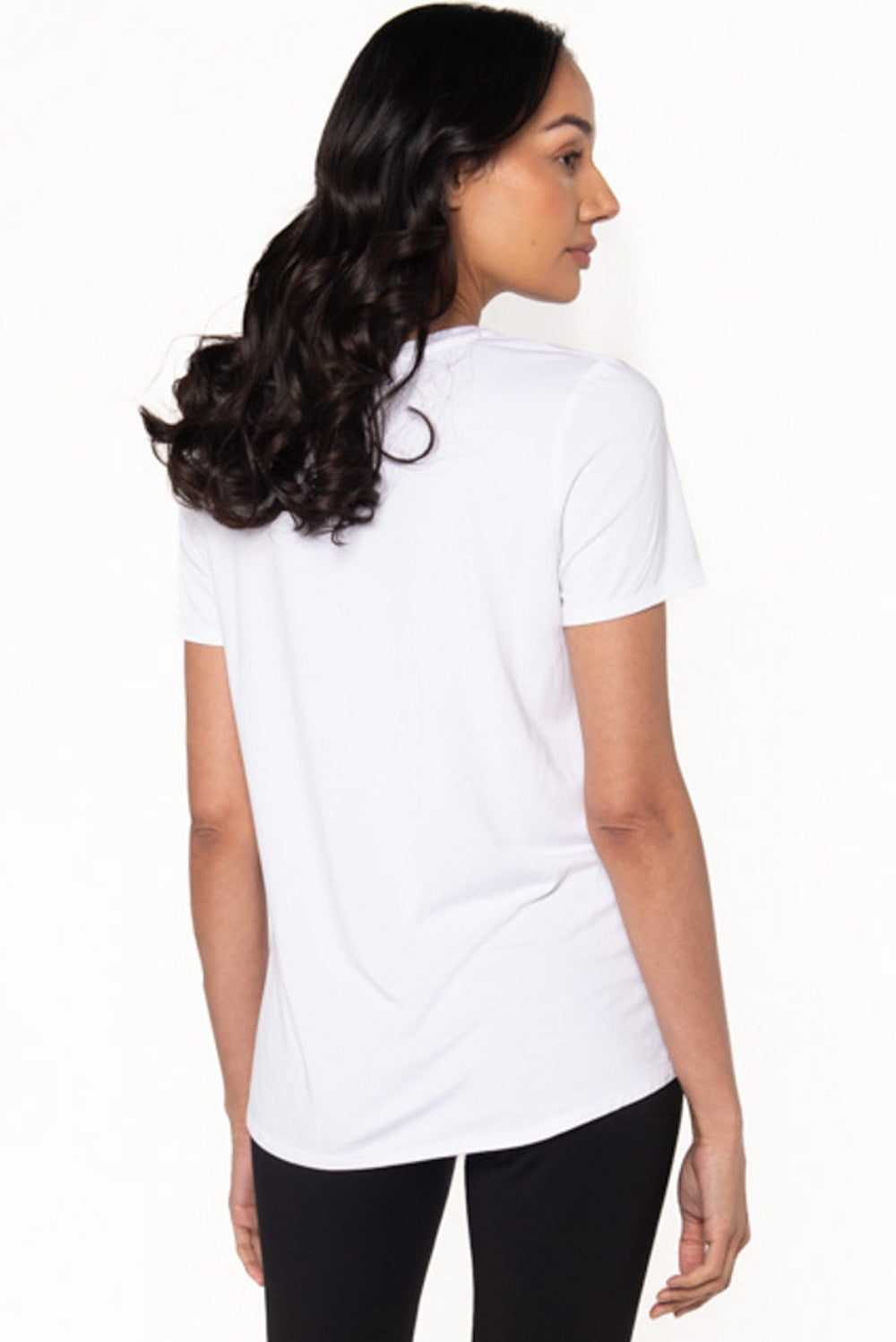 A white bamboo t-shirt with a crew neckline by Terrera. The model is showing the back of the bamboo crewneck t-shirt.
