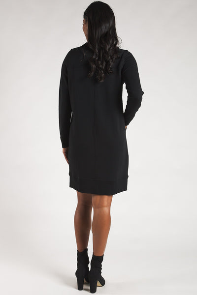 Back view of a woman wearing a black half-zip fleece dress from Terrera.