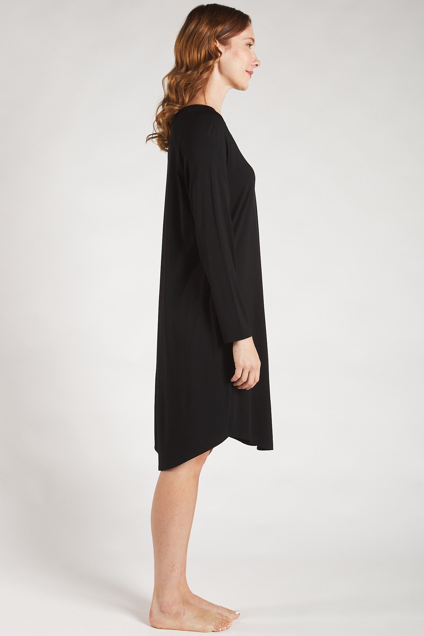 Side view of a woman wearing a soft black bamboo sleep dress from Terrera.
