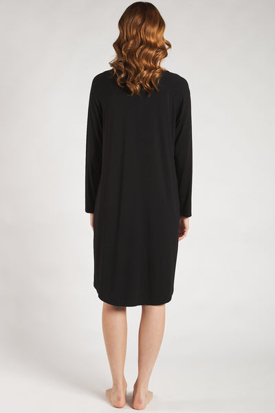 Back view of a woman wearing a black sleep dress made from sustainable bamboo.