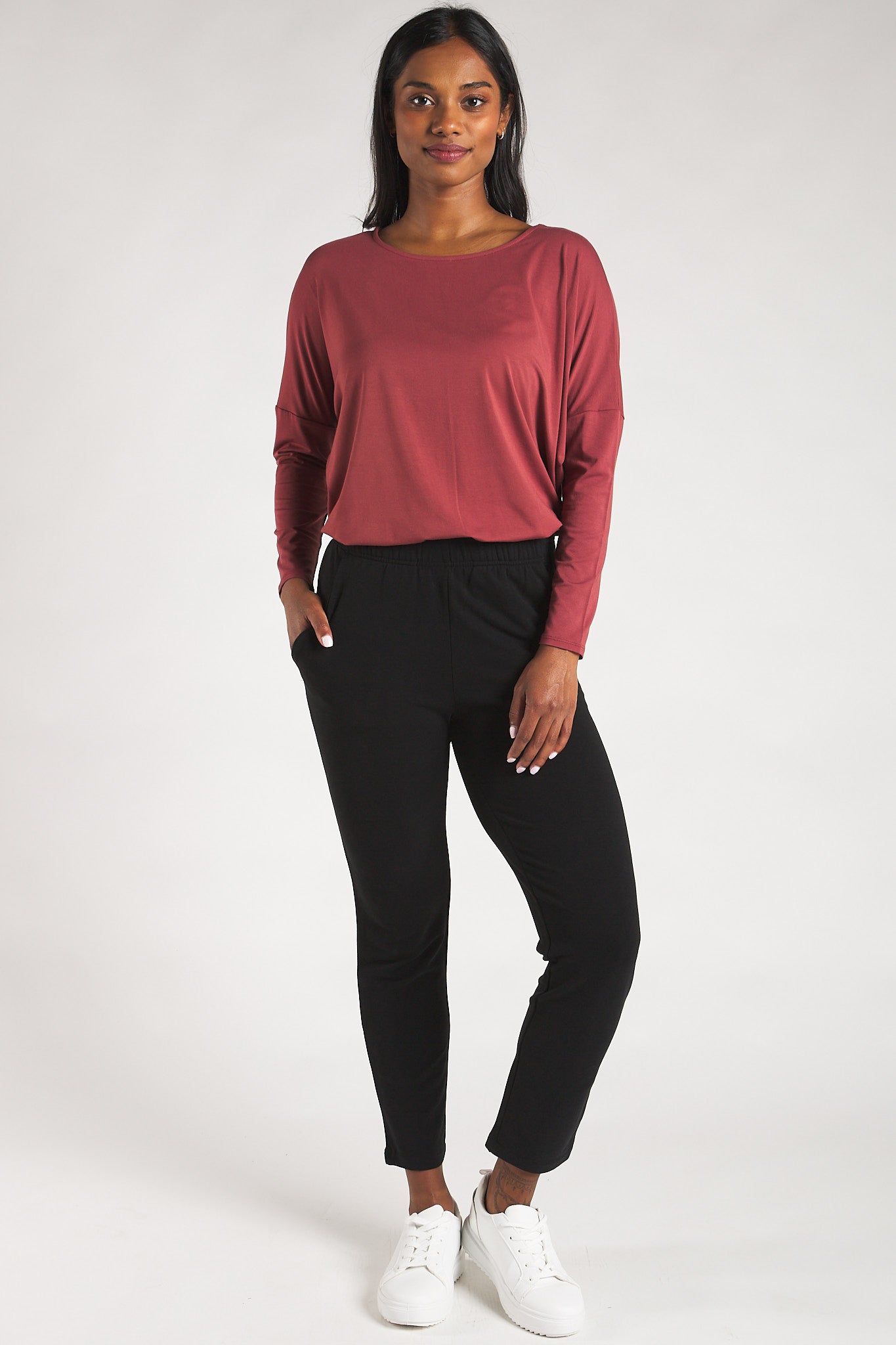 Woman styling a sustainable bamboo long sleeve top in Rosewood by Terrera.