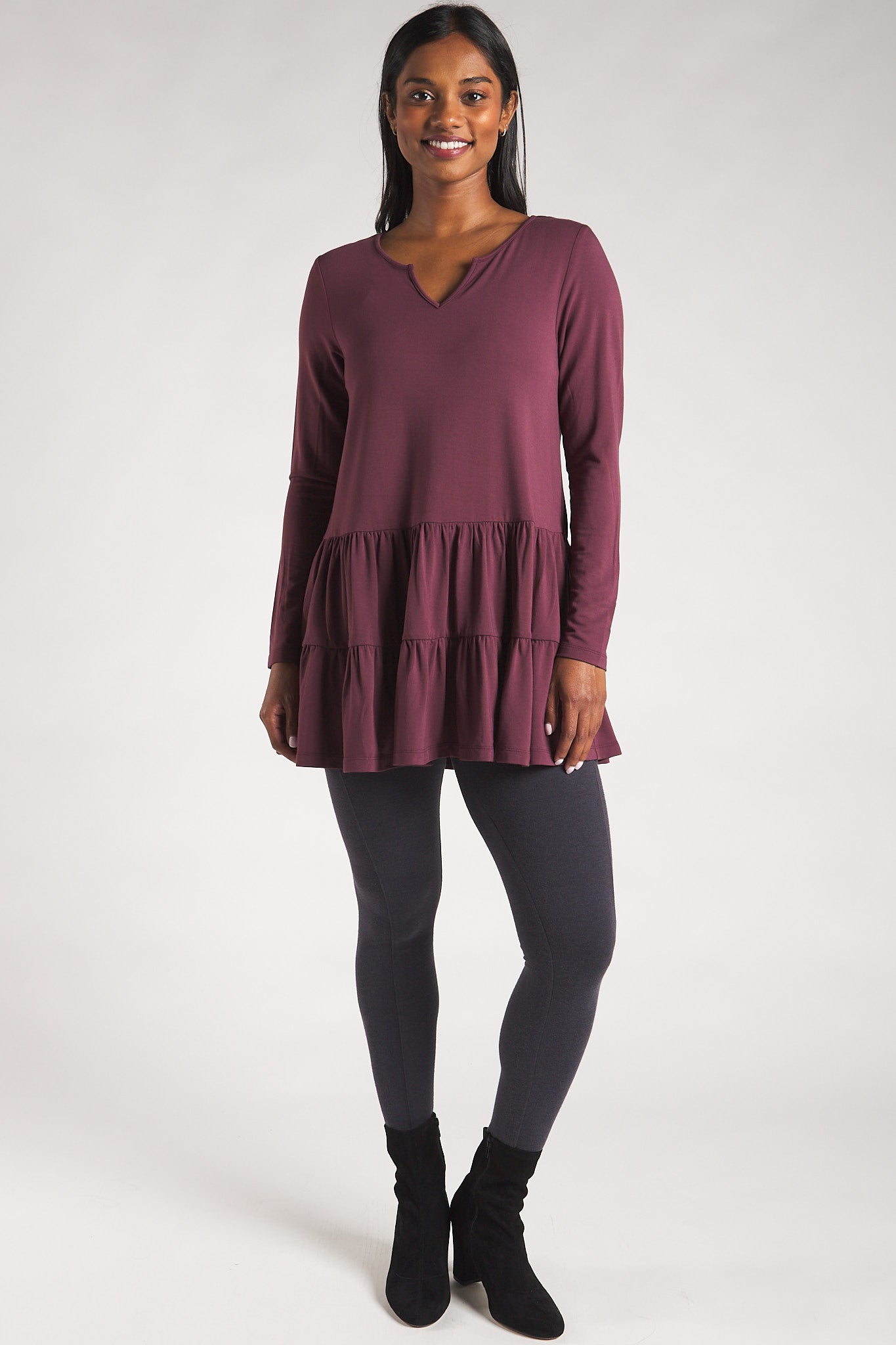 Women's bamboo leggings with pockets styled with tiered tunic long sleeve top.