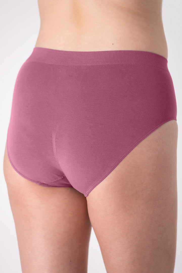 Pink high-waisted underwear on a plain background showing the back, with ruching for definition.